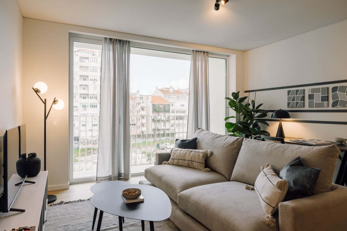 Sofa coffee table lamp and floor lamp living room at 2 bedrooms and shared pool in Areeiro in Lisbon Student Accommodation