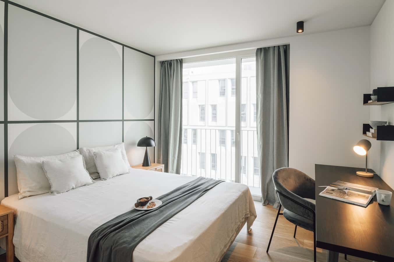 Bed with white linens and pillows study desk and chair bedroom at 2 bedrooms and pool in Areeiro in Lisbon Student Accommodation