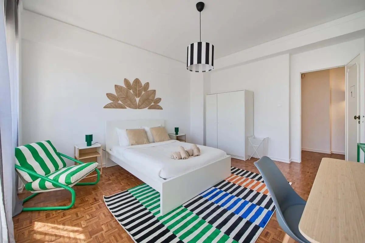 Bed side table chair and rug bedroom at Room in a 9-bedroom apartment in Praça Alvalade, Lisboa - Room 1 in Lisbon Student Accommodation