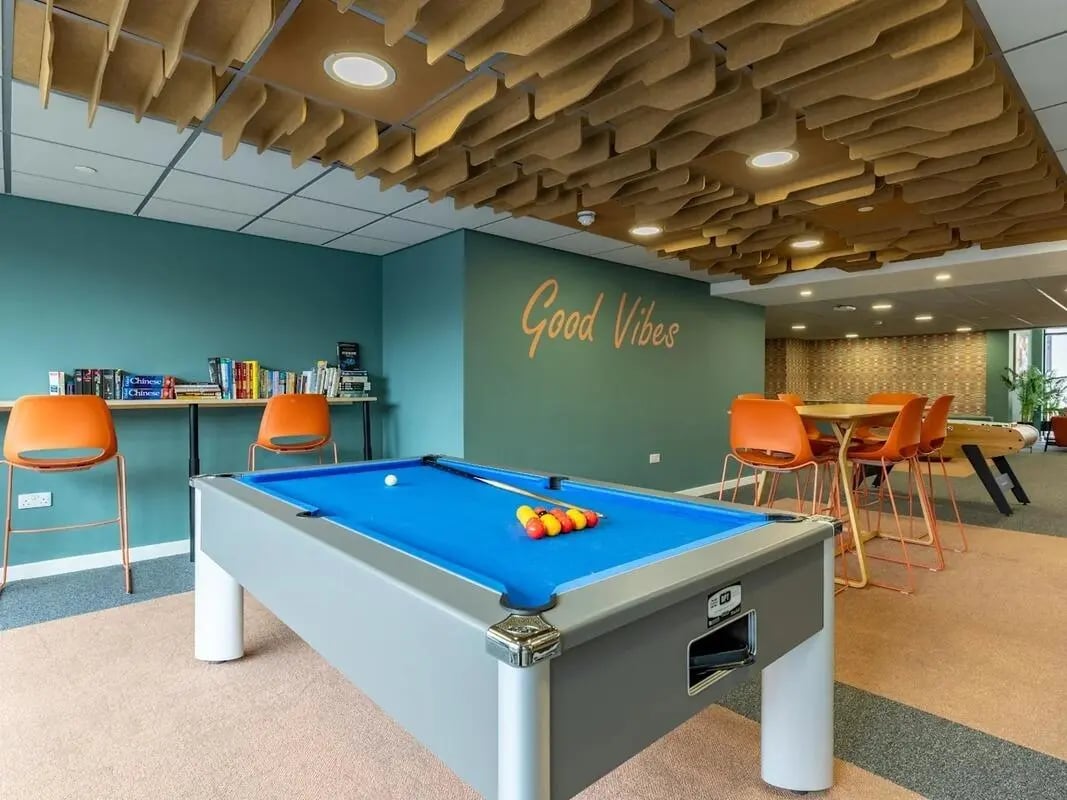 Pool table and orange chairs common area at Radford Mill in Nottingham Student Accommodation