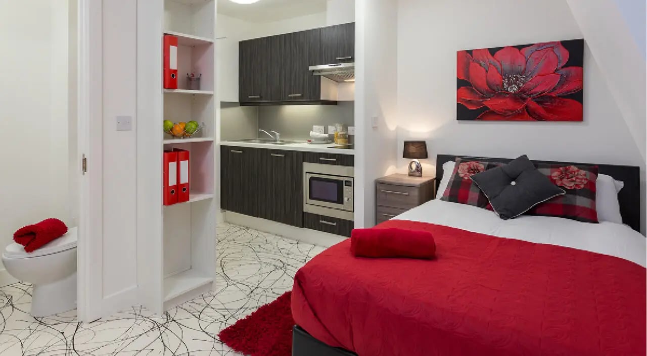 Studio apartment with bed and kitchen area at Queens Gate in Southampton Student Accommodation
