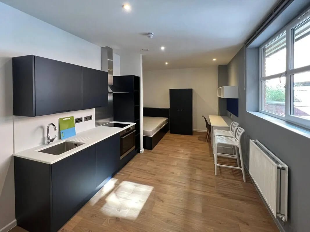 Kitchen bedroom study desk and chairs studio apartment at Allen Court in Manchester Student Accommodation