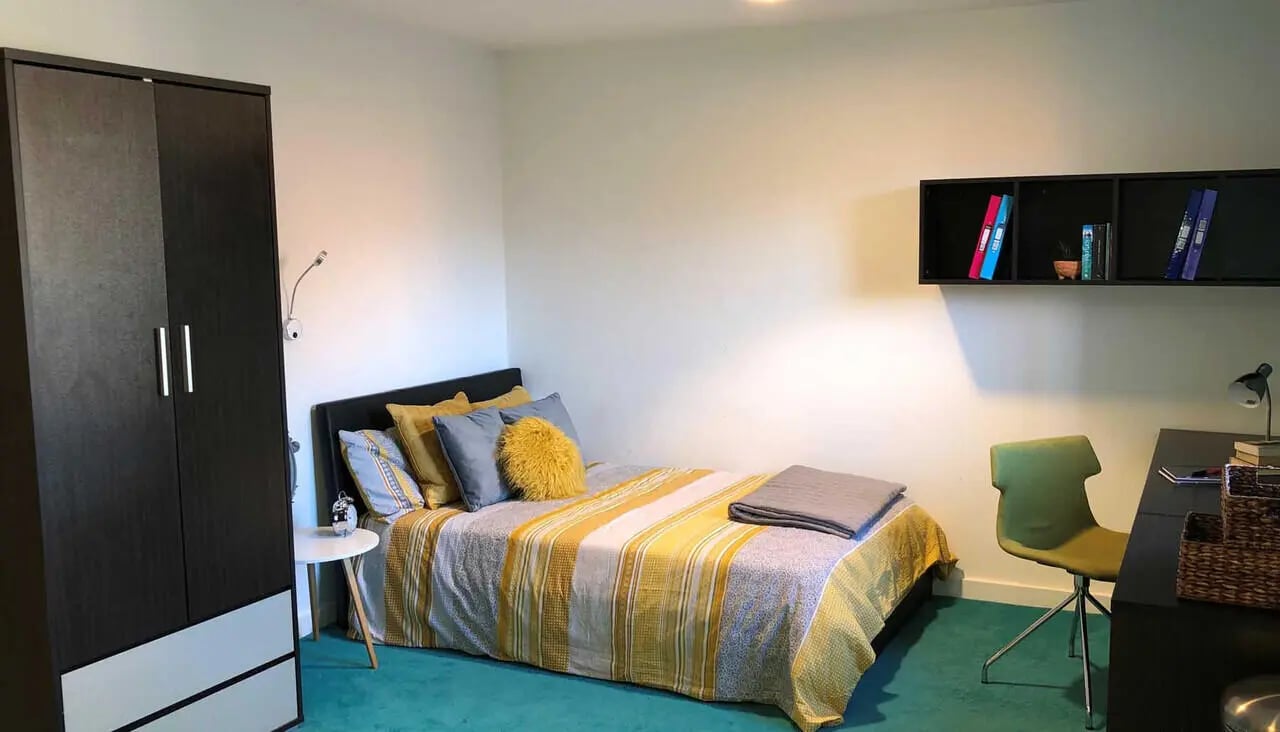 Wardrobe bed desk and chair bedroom at Plato House in Liverpool Student Accommodation