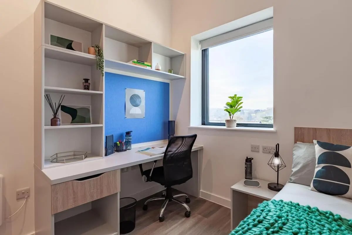 Desk shelves chair bed and window study area at Hill View Place in Exeter Student Accommodation