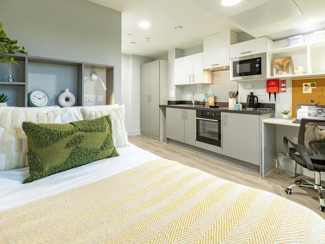 Bed kitchen area with microwave and desk studio apartment at Venue Studios in London Student Accommodation