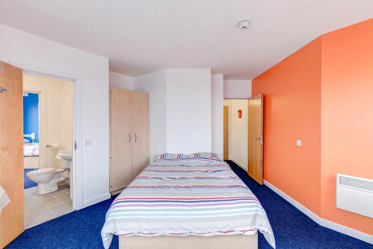 Bed wardrobe and en-suite bathroom bedroom at Dunn House in Sunderland Student Accommodation