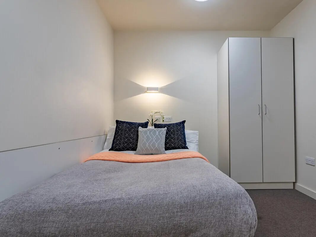 Bed wardrobe pillows blanket bedroom at Powis Place in Aberdeen Student Accommodation