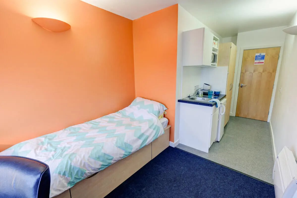 Bed kitchenette and door studio apartment at Dunn House in Sunderland Student Accommodation