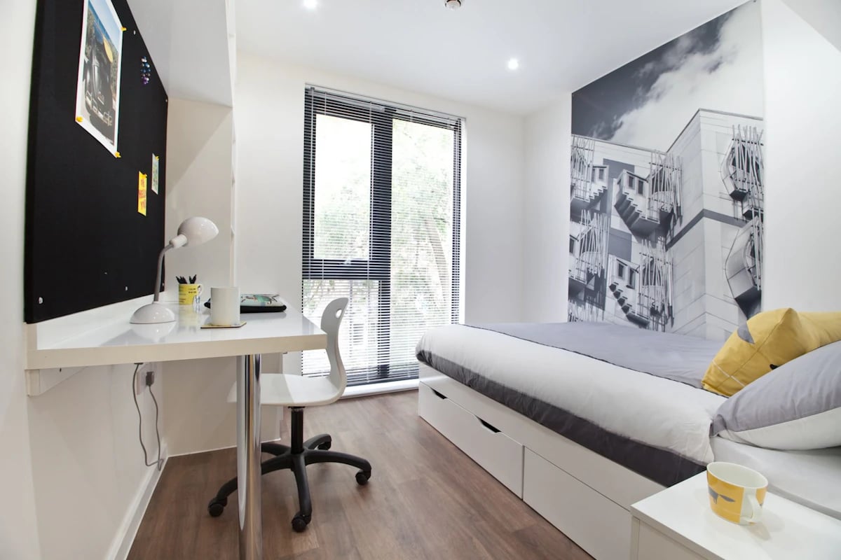 Bed desk black notice board and blinds bedroom at Gateway Apartments in Edinburgh Student Accommodation
