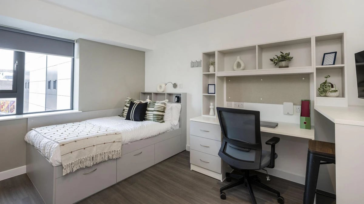 Bed desk and shelving unit bedroom at Holden Court in Brighton Student Accommodation