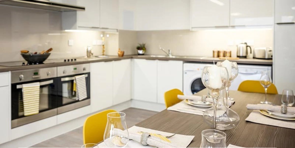 Modern kitchen with dining table and washing machine kitchen at Albert Place in Newcastle Upon Tyne Student Accommodation