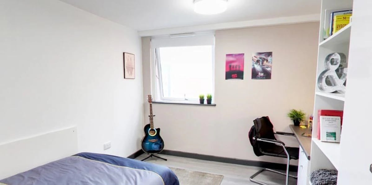 Bed desk guitar shelf and posters bedroom at Albert Place in Newcastle Upon Tyne Student Accommodation