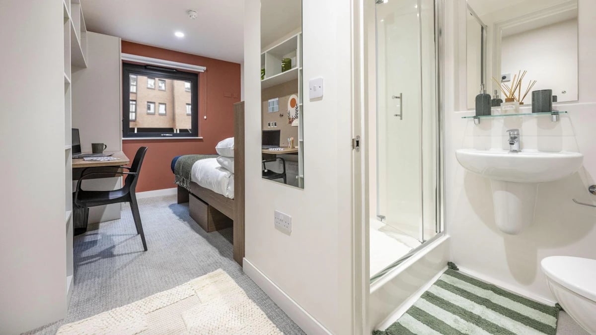 Bed desk chair bathroom sink shower toilet bedroom at Raffles Hall in York Student Accommodation