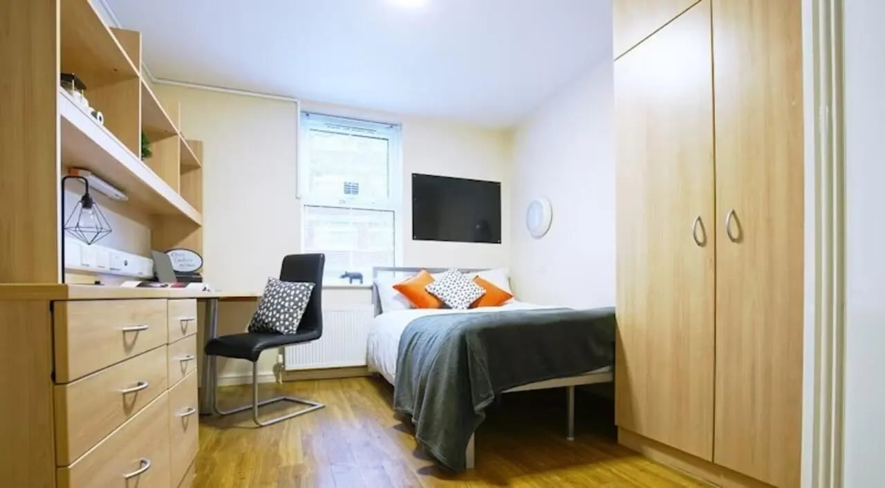 Bed desk chair wardrobe and shelves bedroom at Oxney House & Gardens in Manchester Student Accommodation