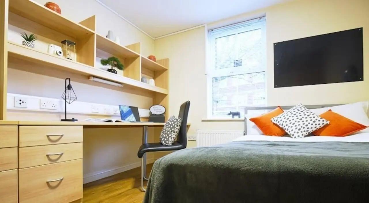 Bed desk shelves with decor and laptop Bedroom at Oxney House & Gardens in Manchester Student Accommodation