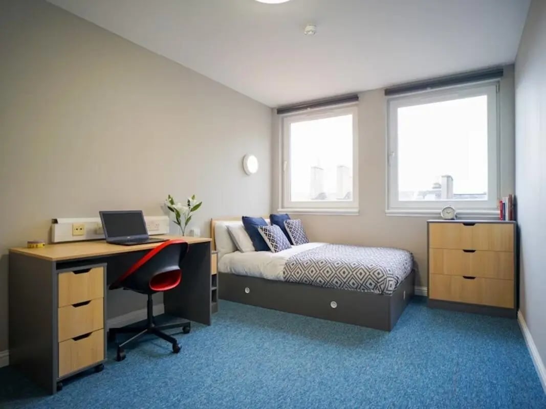 Desk laptop chair bed drawers and windows bedroom at 8 Roxburgh in Edinburgh Student Accommodation