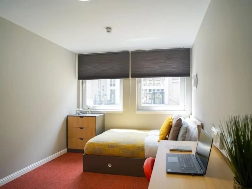 Bed desk dresser with laptop computer bedroom at 8 Roxburgh in Edinburgh Student Accommodation