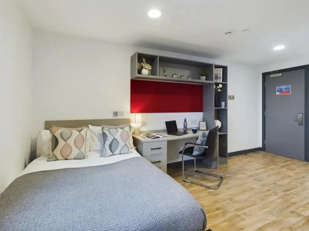 Bed desk chair shelves and laptop bedroom at Red Queen - Coventry in Coventry Student Accommodation