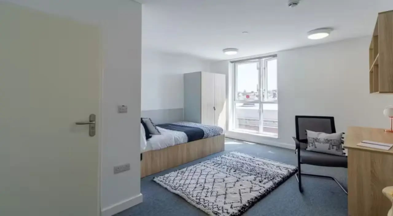 Bed wardrobe rug desk chair bedroom at The Croft in Derby Student Accommodation