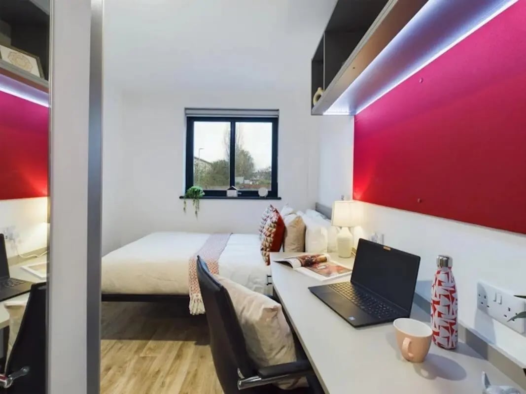 Bed desk laptop and water bottle bedroom at Red Queen - Coventry in Coventry Student Accommodation