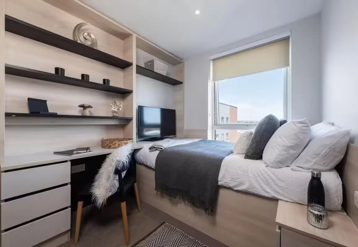 Bed desk TV shelves and window bedroom at Hythe Mills in Colchester Student Accommodation