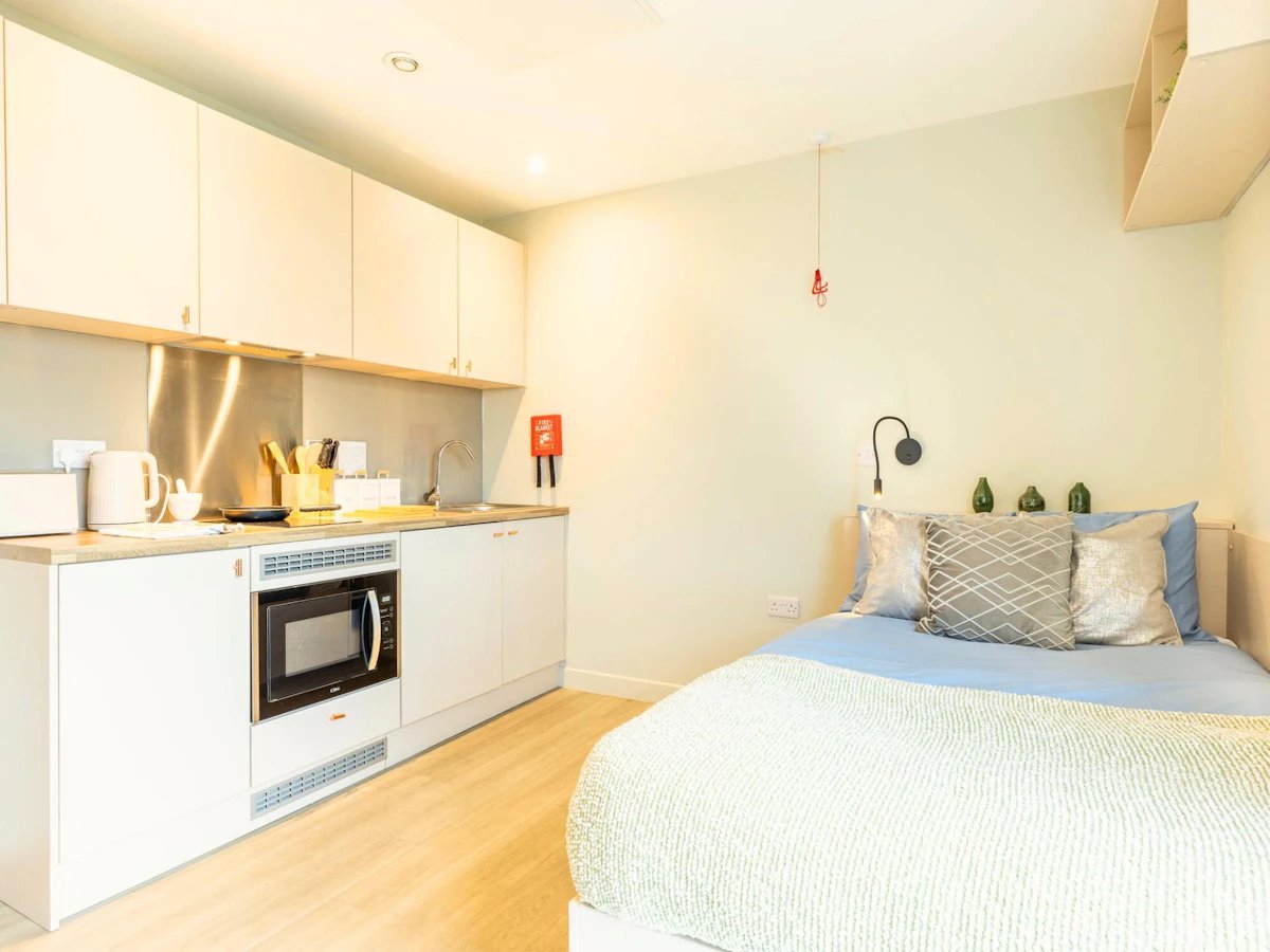 Kitchenette with microwave bed with pillows bedroom at Straits Meadows in Edinburgh Student Accommodation