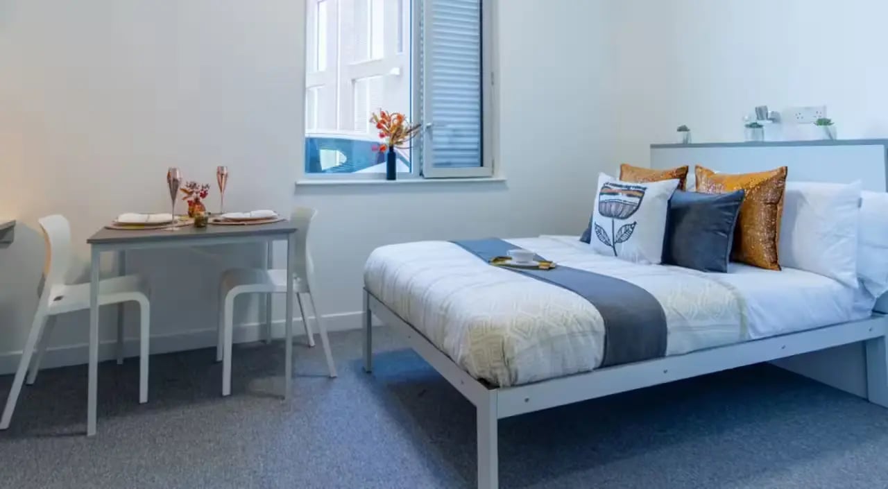 Bed dining table two chairs student bedroom at The Union Leamington in Leamington Spa Student Accommodation