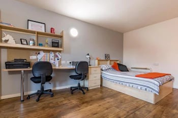 Desk with chairs bed and shelves bedroom at Chambers 51 in Wolverhampton Student Accommodation