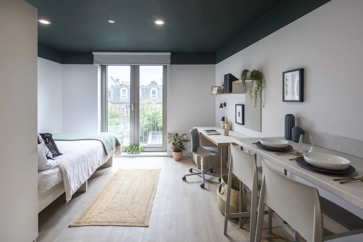Bed desk chair and dining area studio room at The Keel Houses in Edinburgh Student Accommodation