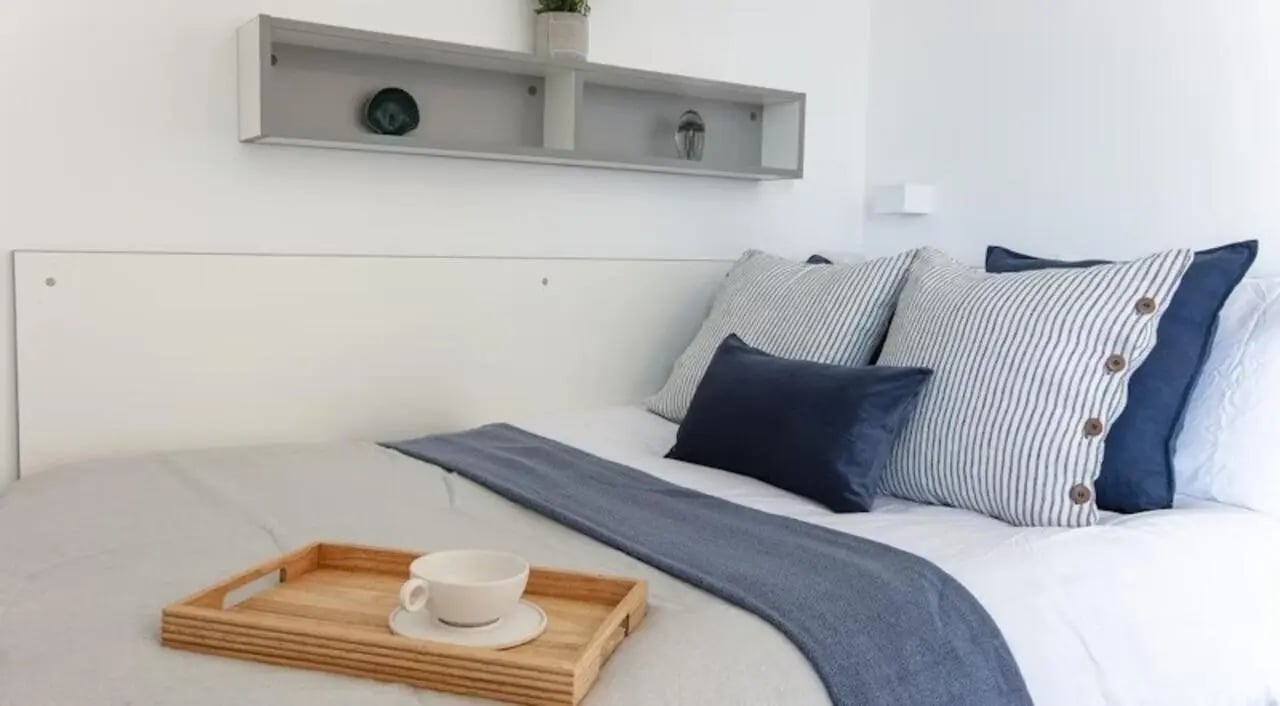 Bed with pillows blanket and tray bedroom at East Shore in St Andrews Student Accommodation