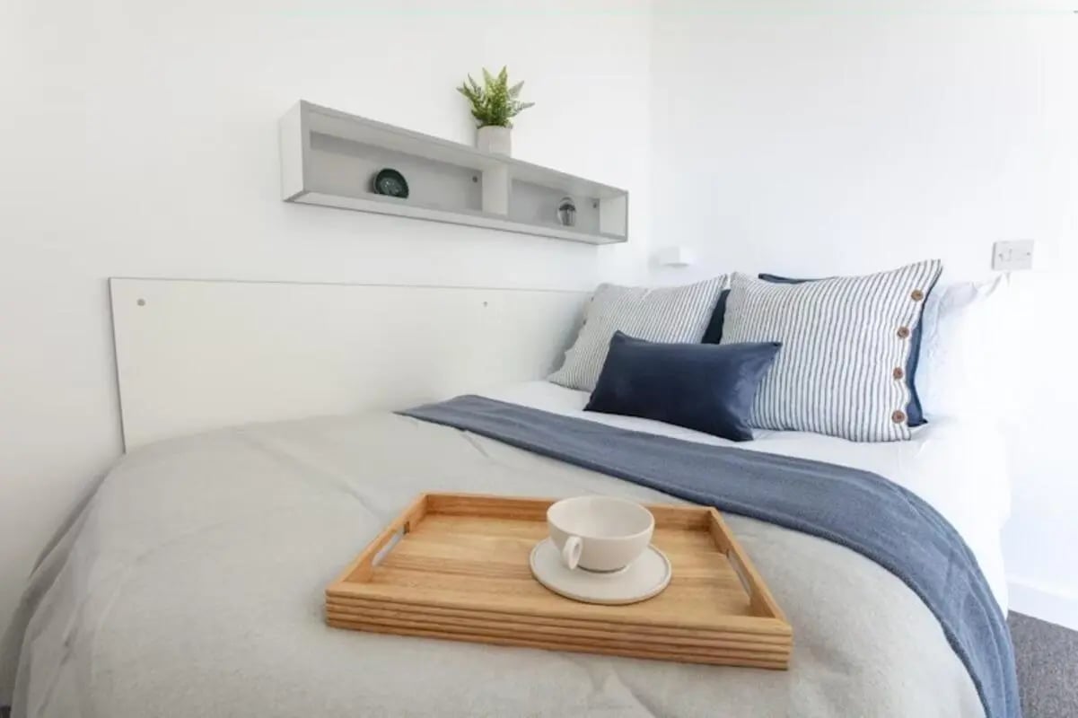 Bed with tray and cup white headboard Bedroom at East Shore in St Andrews Student Accommodation