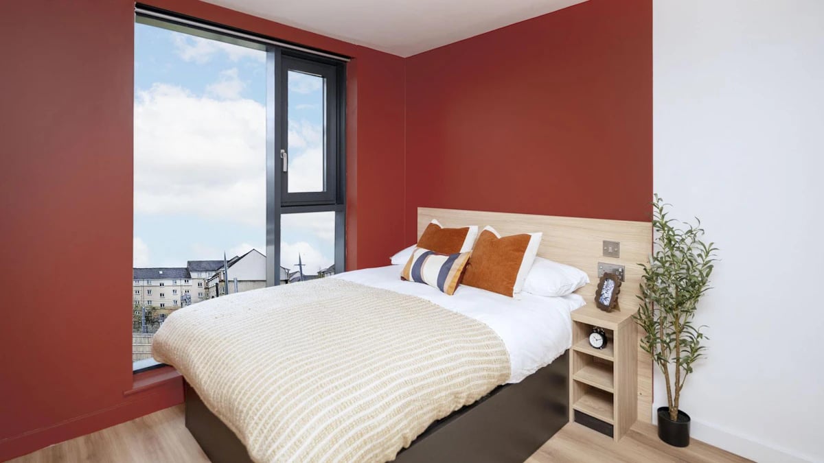 Bed with cushions and nightstand Bedroom at Haymarket Yards in Edinburgh Student Accommodation