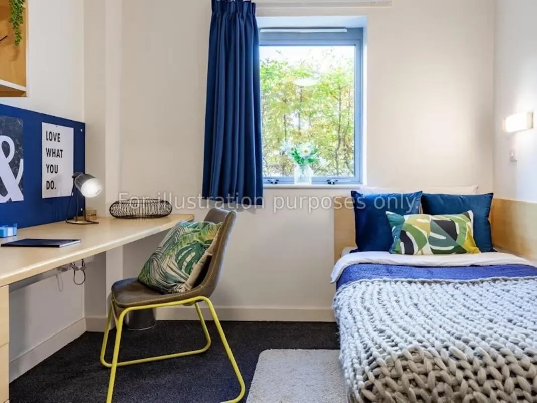 Desk chair bed window pillows bedroom study area at Polhill Park in Bedford Student Accommodation