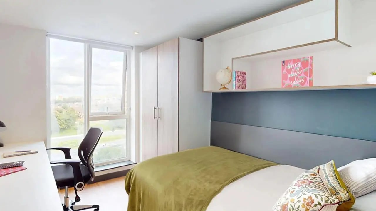 Bed desk closet window and shelves bedroom at Innovo House in Liverpool Student Accommodation