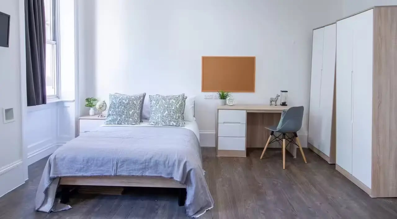 Bed desk chair wardrobe bedroom study area at Bloomsbury Janet Poole House in London Student Accommodation