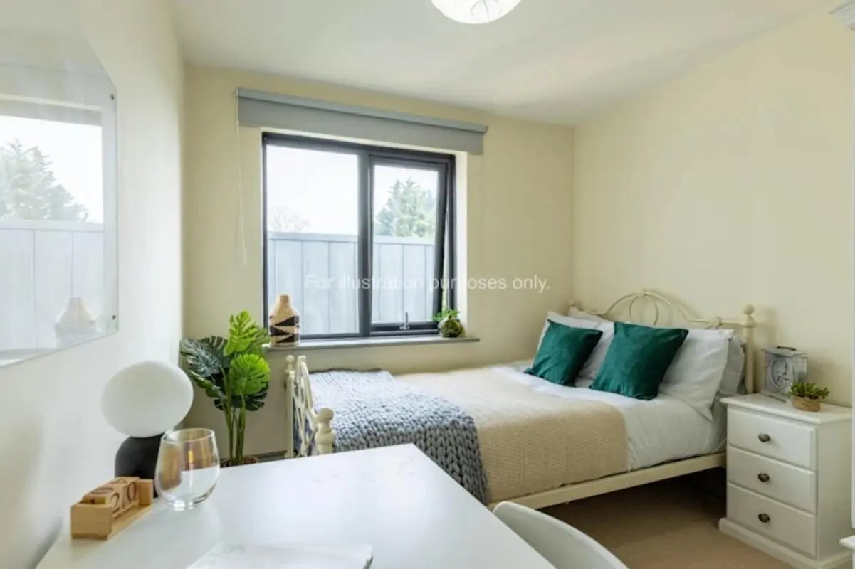 Bed with green pillows and desk bedroom at Mary Morris House in Leeds Student Accommodation