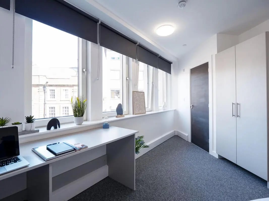 Desk laptop plants and closet bedroom at The Paper Works in Sheffield Student Accommodation