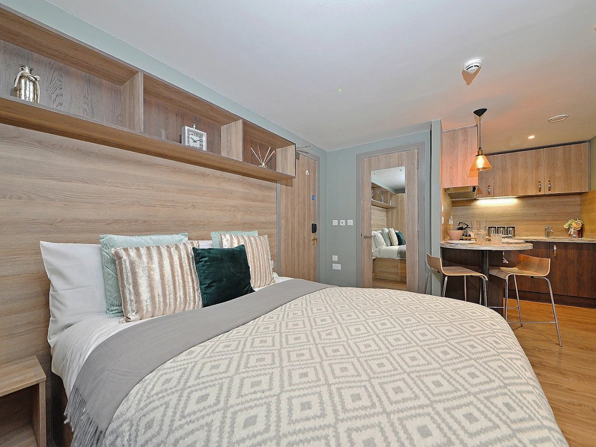Bed kitchen dining area with stools bedroom at Fontenoy Apartments in Liverpool Student Accommodation