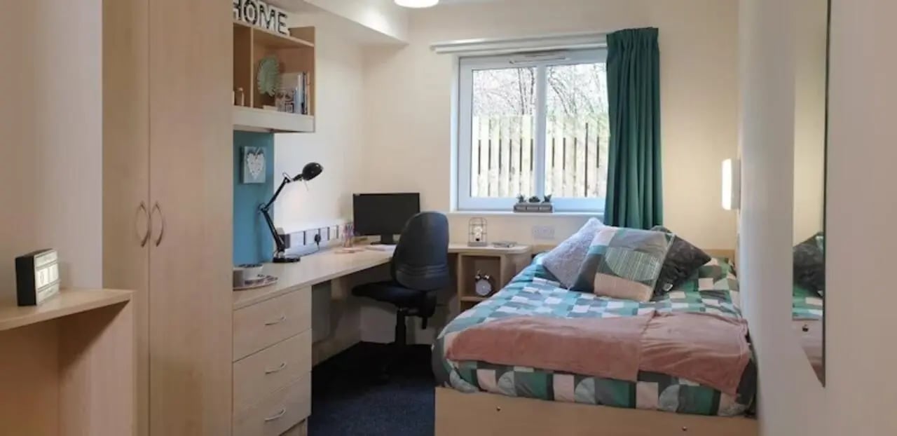 Bed desk wardrobe and shelves bedroom at The Cube - Loughborough in Loughborough Student Accommodation