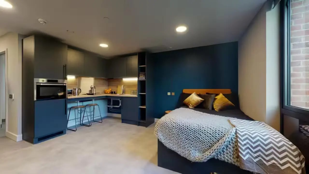 Bed kitchen counter and stools studio apartment at The Vantage in Nottingham Student Accommodation