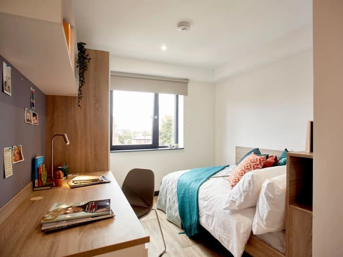 Bed desk and pillows bedroom interior at Eden Square in Coventry Student Accommodation