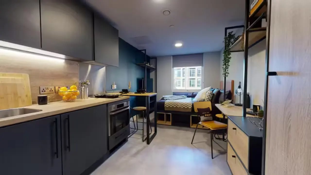 Kitchen area with bed and desk study area at Guilden Village in Guildford Student Accommodation