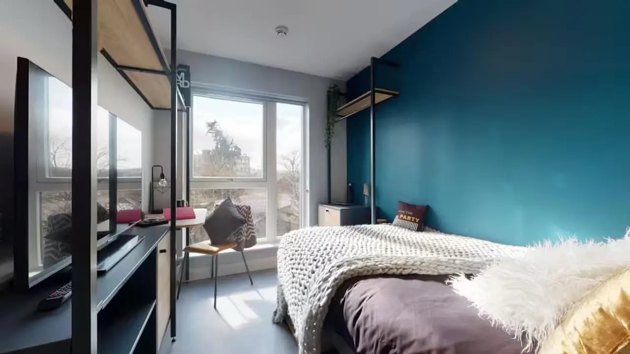 Bed desk shelving units and large windows Bedroom at Guilden Village in Guildford Student Accommodation