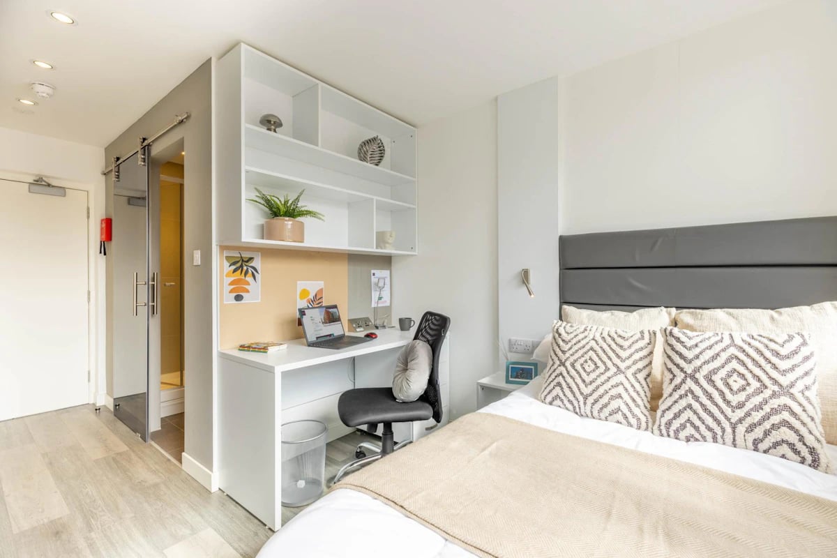 Desk laptop shelving bed with pillows Bedroom at Miura in Nottingham Student Accommodation