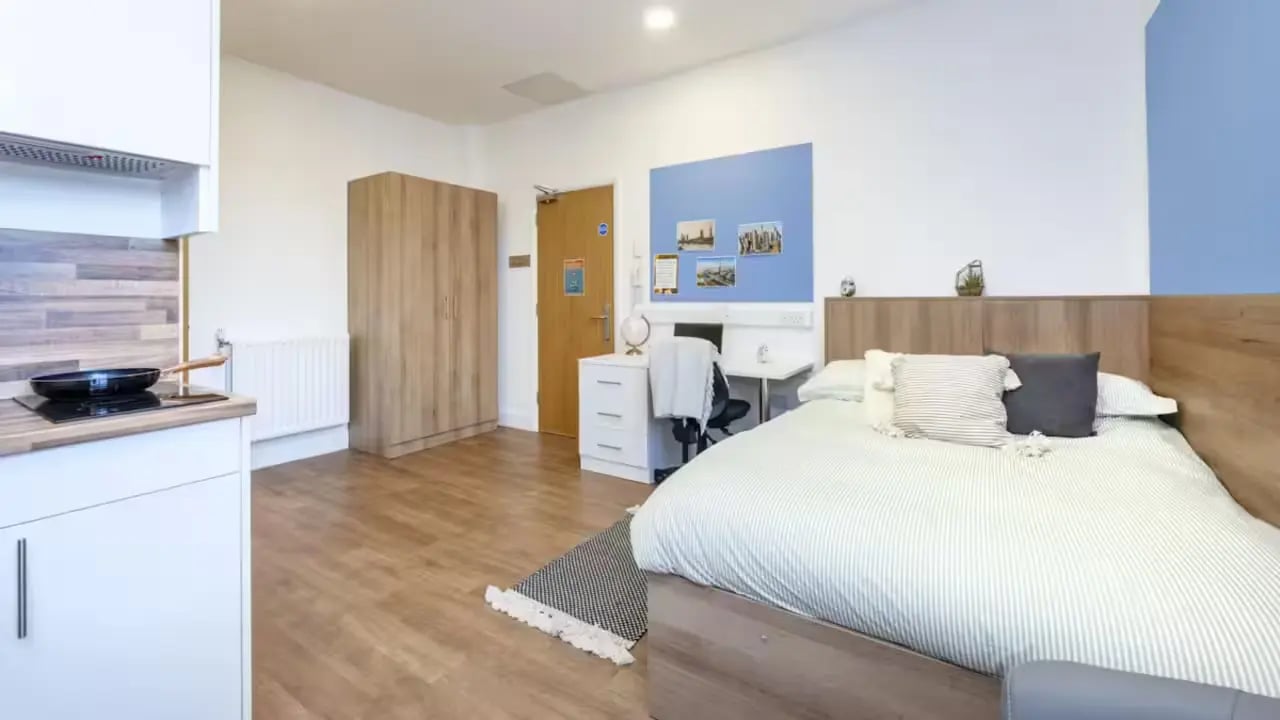Bed wardrobe desk and kitchen unit bedroom at St Leonard's House in Lancaster Student Accommodation