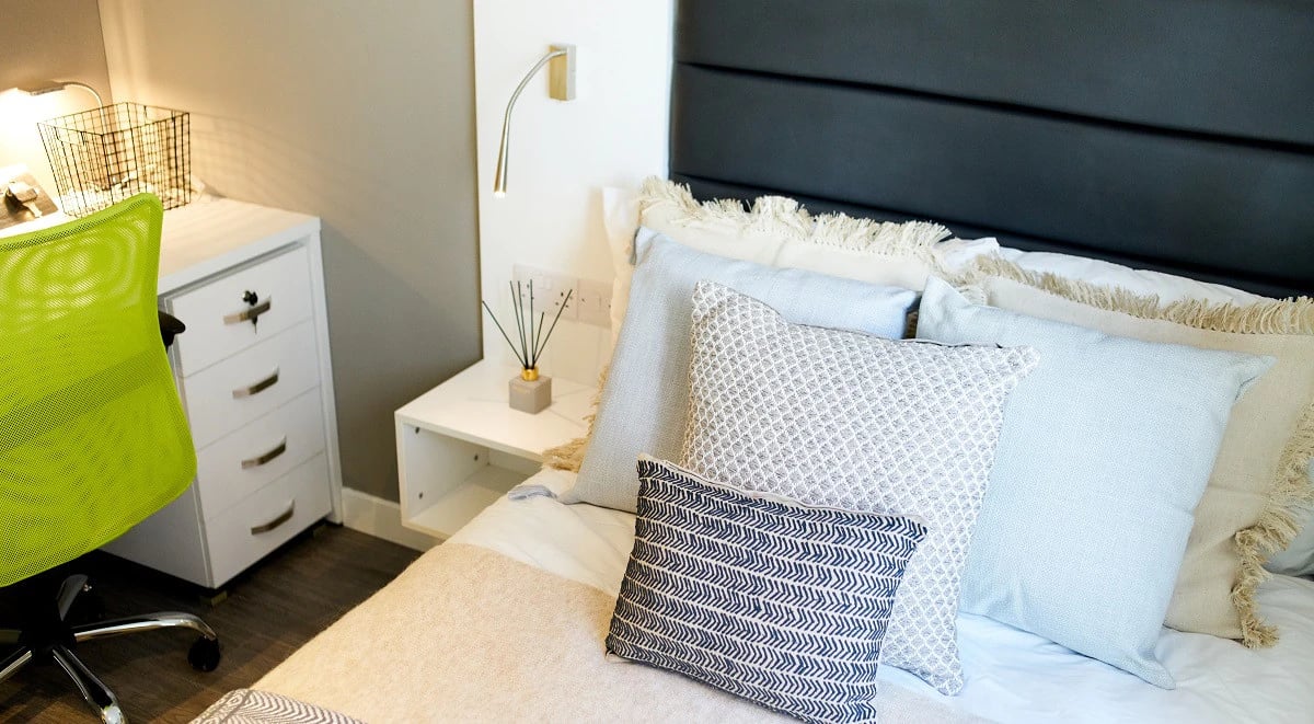 Bed with pillows desk and chair bedroom at Miura in Nottingham Student Accommodation