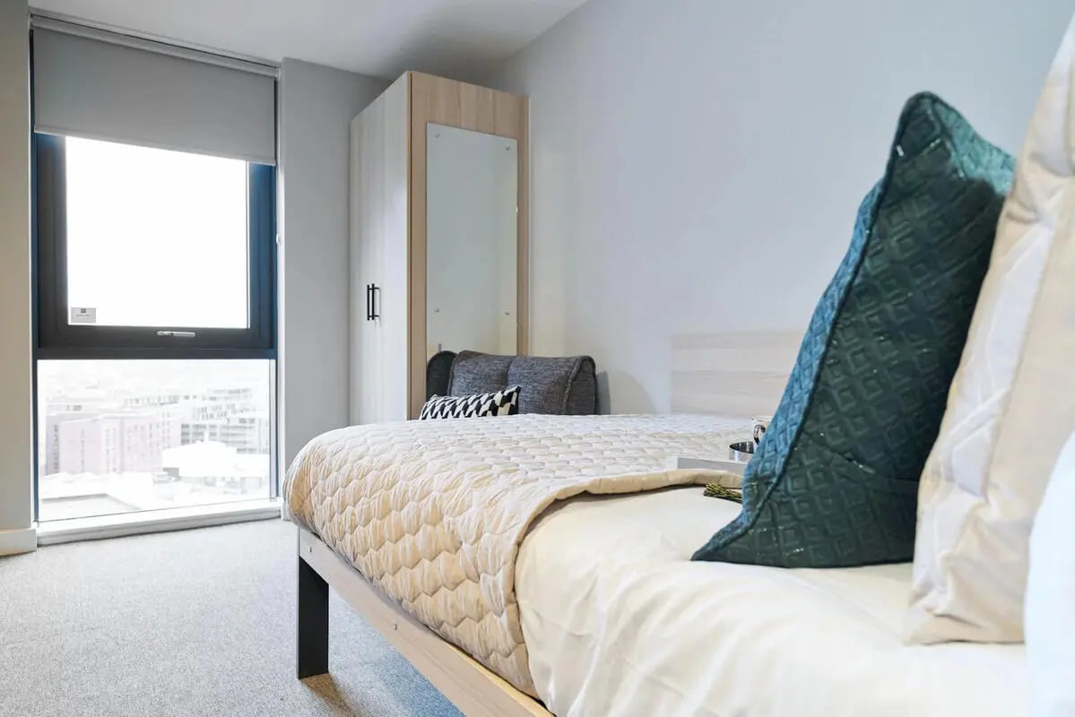 Bed wardrobe with mirror and pillows bedroom at Straits Manor in Sheffield Student Accommodation