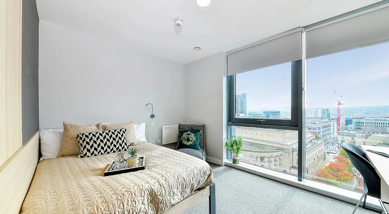 Bed with patterned pillows and tray bedroom at Straits Manor in Sheffield Student Accommodation