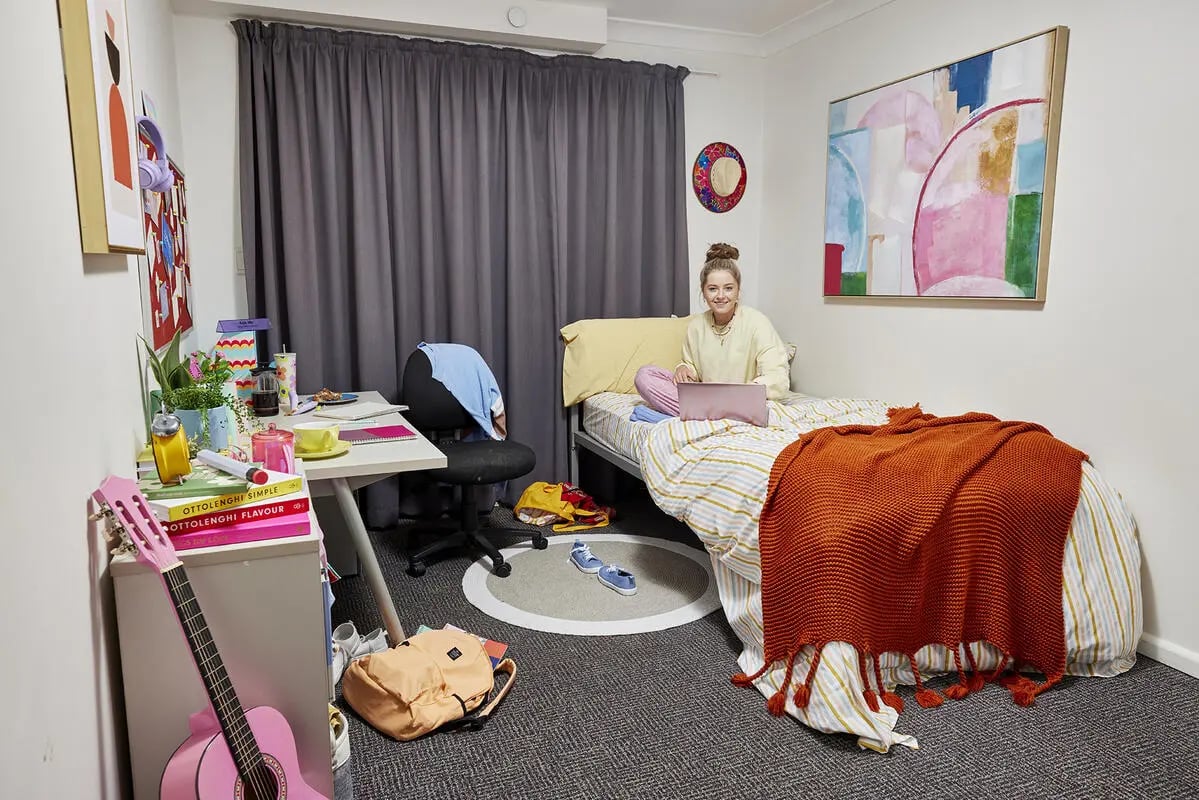 Bed with laptop and desk Bedroom at Boundary x Scape in Sydney Student Accommodation