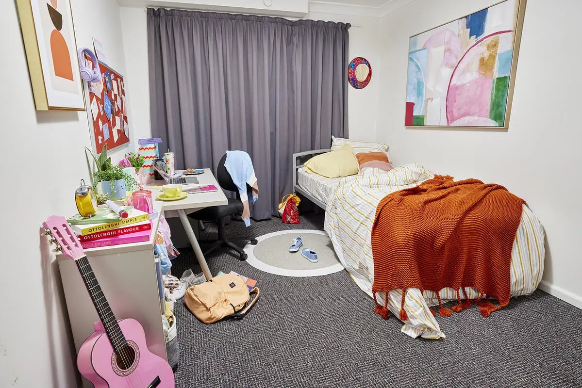 Bed desk guitar and artwork student bedroom at Boundary x Scape in Sydney Student Accommodation